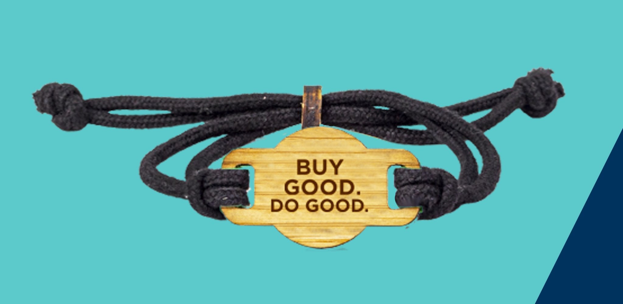 A bamboo bracelet with the words Buy Good Do Good engraved on the front of it. It has a black wristband and a toggle to tighten the strap. The background of the image is teal and navy. 