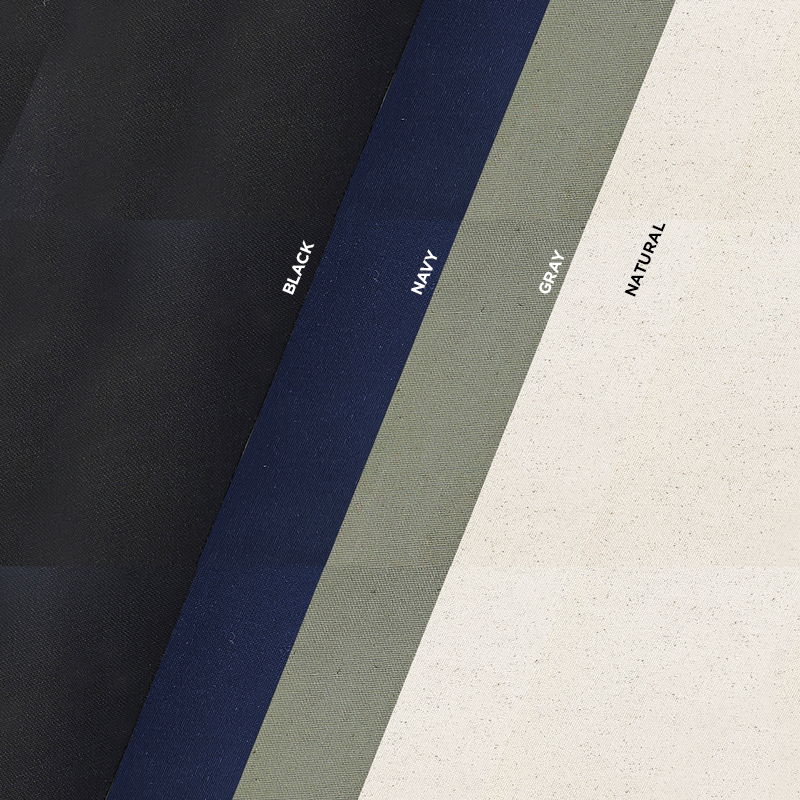 Four colors of organic cotton canvas fabric including black, navy, gray and natural. The fabric swatches are laid one on top of the other at an angle.