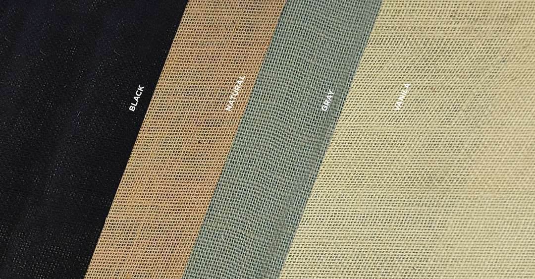 Four colors of jute fabric including black, gray, vanilla and natural. The fabric swatches are laid one on top of the other at an angle.