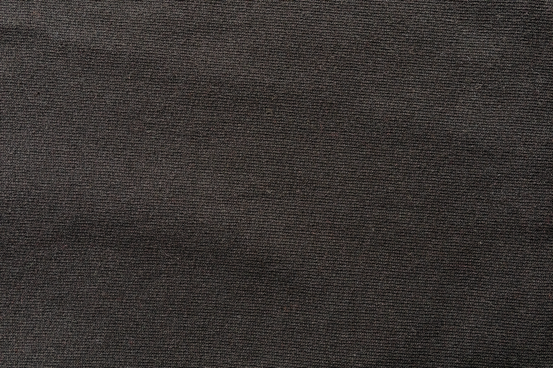 A swatch of Black organic cotton t-shirt fabric.