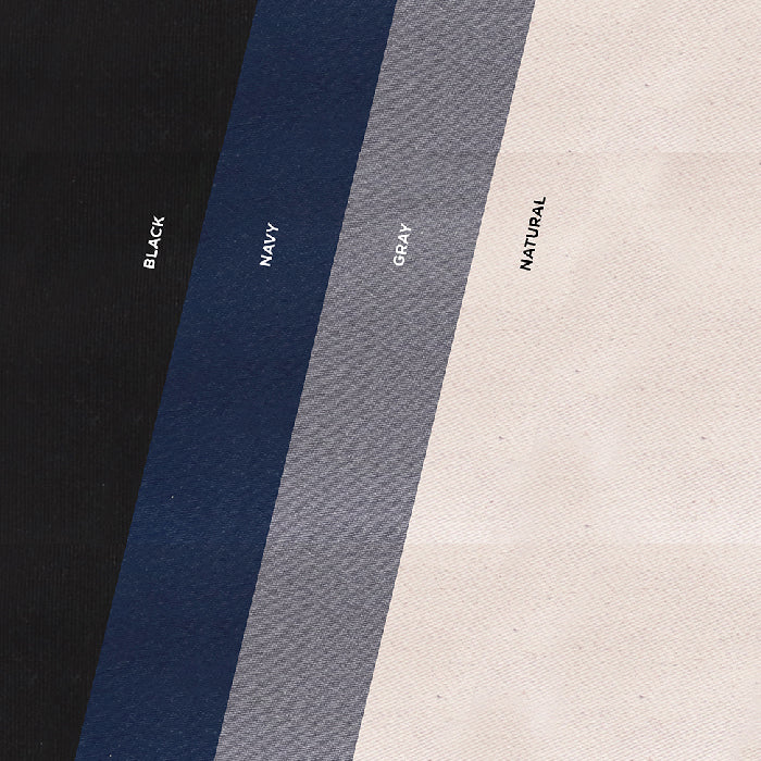 Four colors of organic cotton canvas fabric including black, navy, gray and natural. The fabric swatches are laid one on top of the other at an angle.